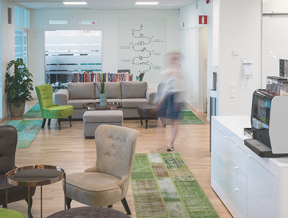 Ett hem trevligt kontor som i första anblick ser tomt ut, men man anar konturerna av en person som går mot kameran.